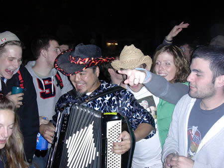 Photo: Me playing accordion for the students at the Crazy Go Nuts University homecoming street party.