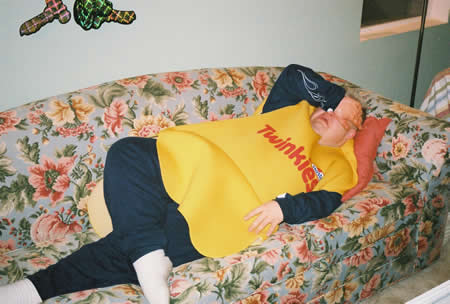 Photo: Tired guy in Twinkie costume on couch.