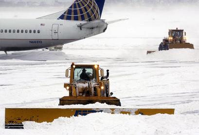 Tractor clearing snow at Logan Airport.