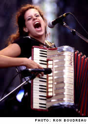 Photo: Regine Chassagne from The Arcade Fire playing accordion.