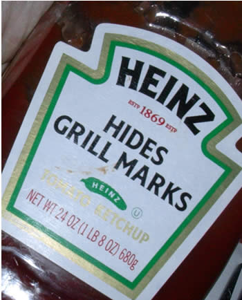 Photo: Unusual label for Heinz ketchup: 'Hides grill marks'.