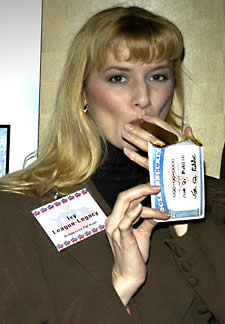 Photo: Woman lighting a cigar with a burning US Social Security card.