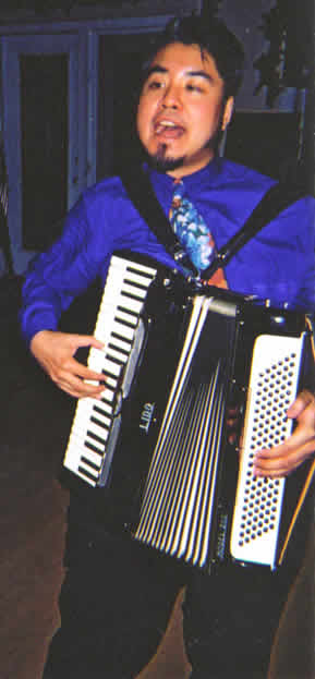 Photo: Joey deVilla palying accordion at Ashley Bristowe's and Chris Turner's Wedding in Canmore, Alberta -- January 2004.