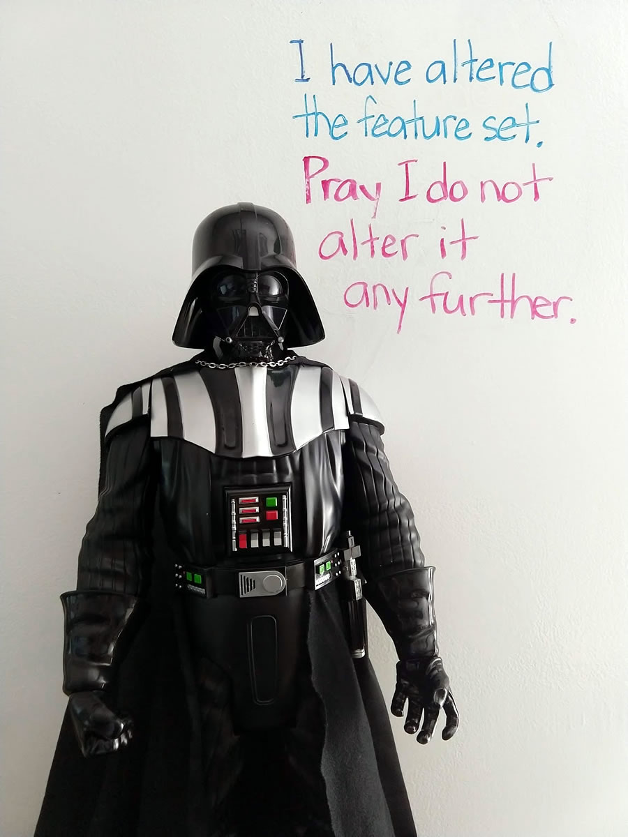 Status of Darth Vader with the caption behind him written on whiteboard: 'I have altered the feature set. Pray I do not alter it any further.'