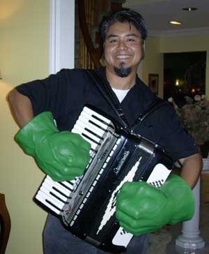 Joey playing accordion with 'Hulk Hands'.