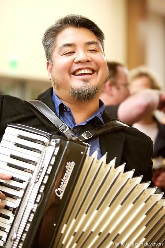 Joey deVilla plays accordion at The Ajax Experience, October 2006. Photo by James Duncan Davidson.