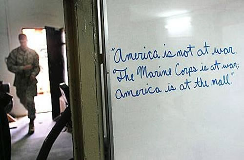 Photo of Marine barracks whiteboard that says: 'America is not at war. The marines are at war. America is at the mall.'