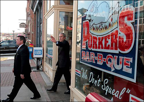 George W. Bush leaves Porker's barbecue, whose slogan is 'We Don't Squeal'.