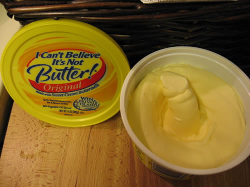 Phallic shape in an open tub of 'I Can't Believe It's Not Butter'.