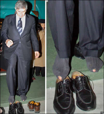 AP photos of Paul Wolfowitz taking off his shoes at a mosque, revealing holes in both his socks.