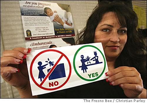 Woman showing the 'Don't abandon your baby' sign.