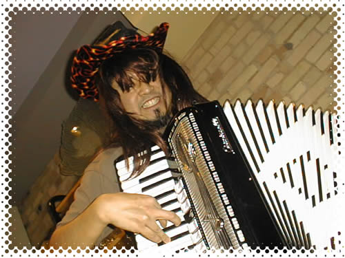 Joey in a wig, rocking out on accordion.