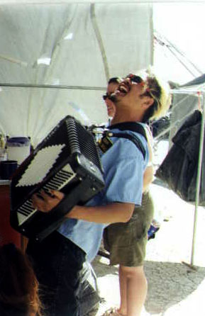 Joey playing accordion at Burning Man 1999.
