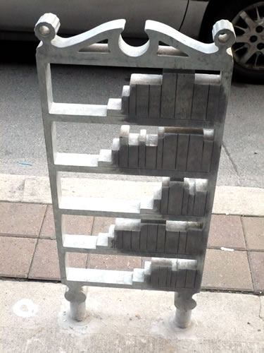 Bike post stylized to look like a bookshelf, Queen Street West, Toronto.