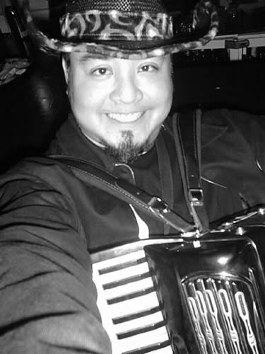 Joey deVilla with accordion, triumphant after the go-go dancing gig.