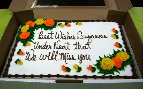 Cake with writing: “Best Wishes Suzanne / Under Neat that / We Will Miss You”