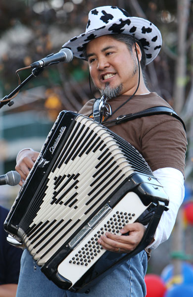 Joey deVilla making his “rock face” as he plays accordion