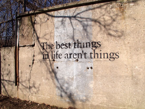 Photo of stencil graffiti on a wall: “The best things in life aren’t things”