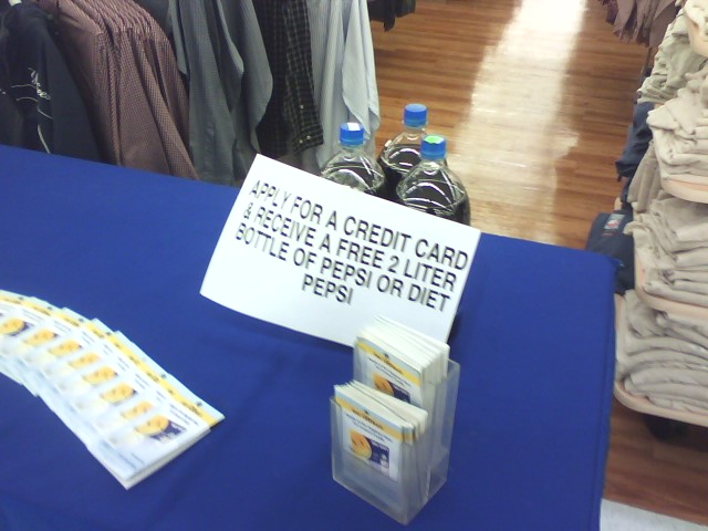 Table at Wal-Mart with sign: “Apply for a credit card and receive a free 2-liter bottle of Pepsi or Diet Pepsi”