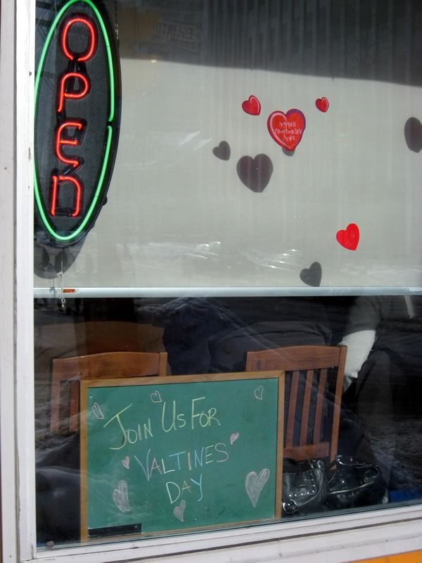 Chalkboard in restaurant window: “Join us for Valtines Day!”