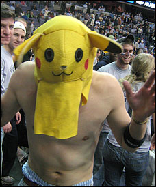 Shirtless man wearing the head from a Pikachu costume