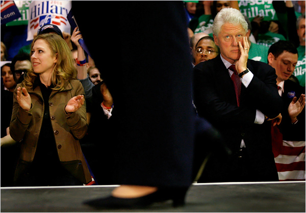 Bill Clinton looking up at Hillary with a resigned expression.