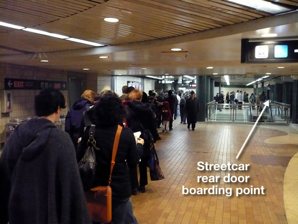 Long line to the rear entrance of the Spadina streetcar at Spadina station