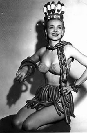 Black and white photo of a woman wearing a bikini and sausages