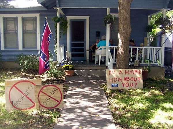 House with Confederate flag and badly spelled signs