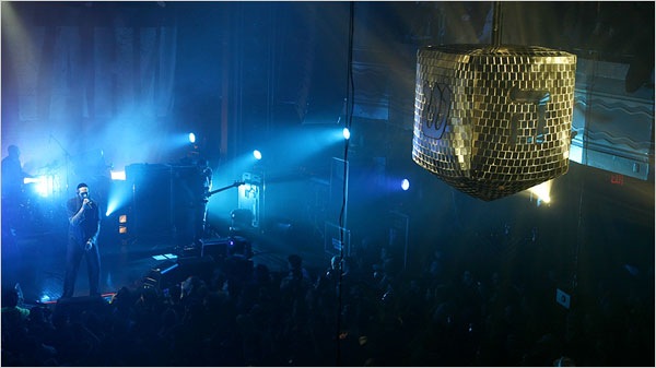 Mastiyahu onstage with a dreidel disco ball in the foreground