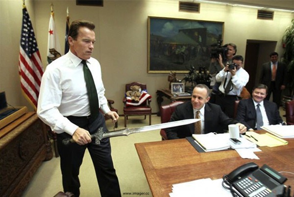 Governor Arnold Schwarzenegger holding a sword at a meeting