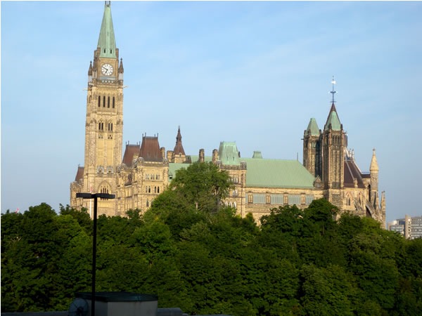 Parliament buildings in Ottawa, with tress in the foreground