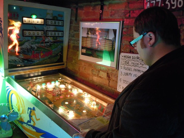 Pete playing pinball at the Black Dice Cafe