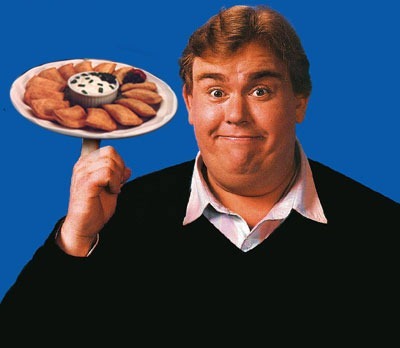 John Candy holding a plate of pierogies