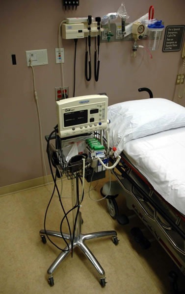 Automatic blood pressur cuff, poised beside an ER bed