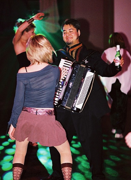 Photo of Joey deVilla dancing with a blonde woman who is fondling his accordion.