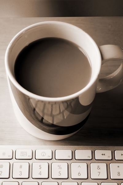 Mug of coffee and an Apple wireless keyboard