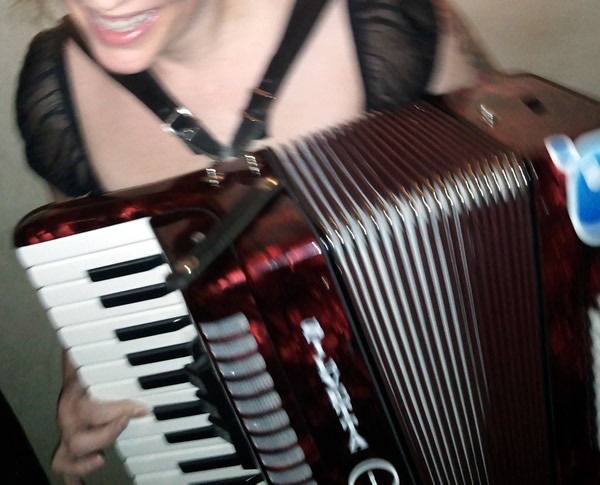 A woman playing Joey deVilla's accordion