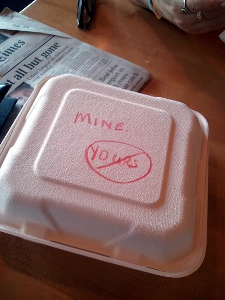 Take-out container with the word "Mine" and "Yours" in a "forbidden" circle.