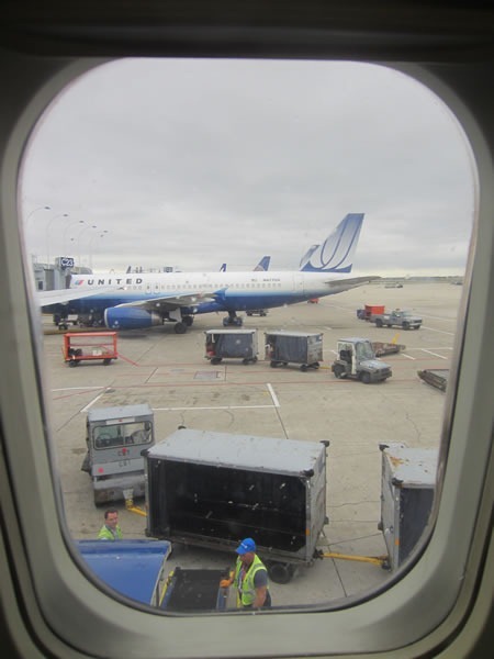View from an airplane window, looking at a United Airlines jet at O'Hare