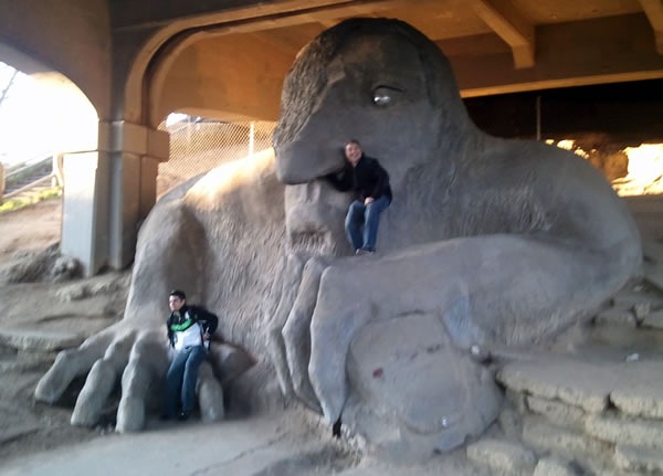 Joey deVilla poses with the giant troll under the bridge in Seattle, with his arm up the troll's left nostril