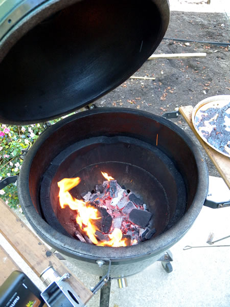 Close-up of wood burning inside a "Big Green Egg" outdoor cooker