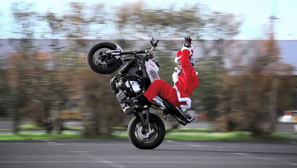 Photo: Santa on a motorbike, popping a wheelie