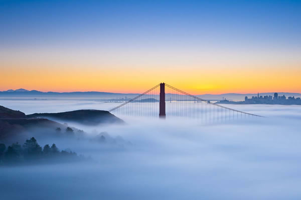The Golden Gate Bridge, enveloped in fog.