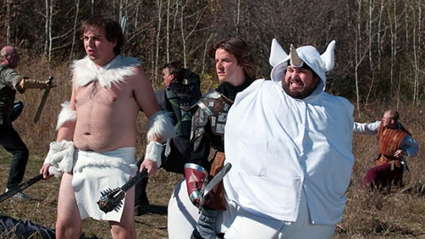 Still from 'Lloyd the Conqueror': tubby dude dressed as barbarian, guy dressed as paladin, and another guy dressed up as a unicorn.