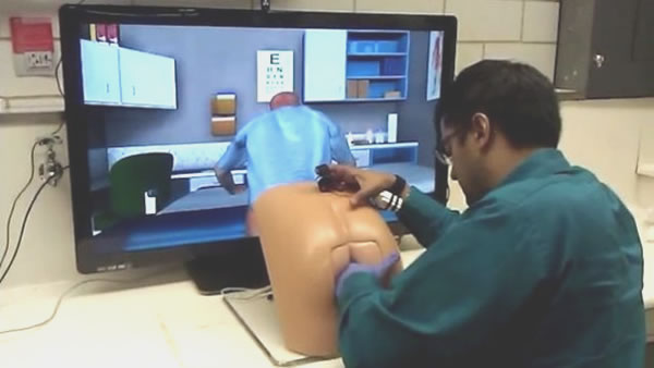 Doctor using butt-shaped interface for a prostate exam simulator