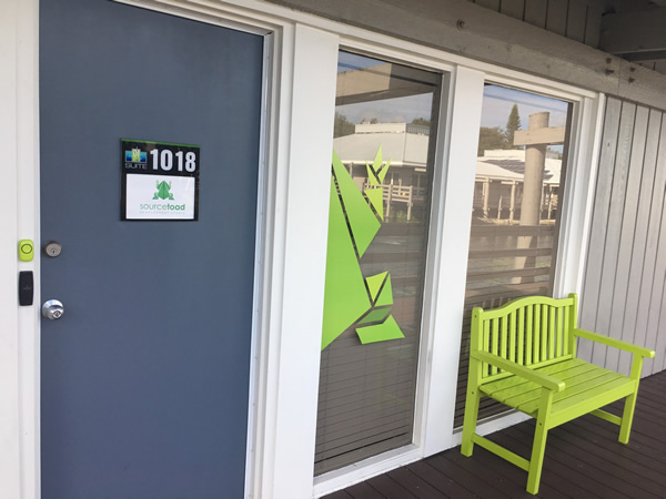 The front door and bench outside Sourcetoad’s office, which is in a “boardwalk” style office complex over a pond.