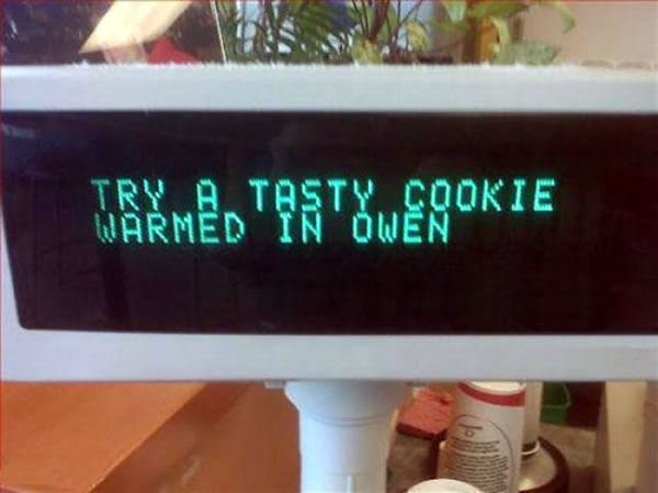 Grocery cash register digital readout that says 'Try a tasty cookie warmed in Owen'.
