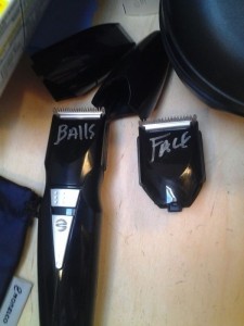 Electric razor with two attachments, one labelled "BALLS", the other labelled "FACE"