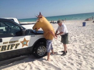 Bay County Sheriff officer handcuffs man in a moose costume